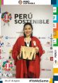 Alejandra Carrasco at the Perú Sostenible event, proudly holding an award, showcasing her commitment to sustainability.