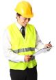 Happy worker in a safety vest and hard hat writing notes on a clipboard, symbolizing job safety and site management.