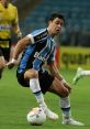 Giuliano Caiazza dribbling a soccer ball in a heated match, showcasing skills and teamwork on the field.