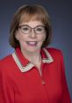 Lori Edwards smiling in a red sweater, showcasing her professional demeanor and friendly personality.