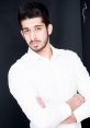 Portrait of a young man in a white shirt, showcasing confidence with crossed arms against a dark backdrop, Erfan Razmi style.