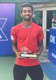 Megh Patel proudly holds his trophy, celebrating victory in the Boys U18 Doubles at the Fenestral Open tournament.