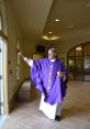 Clergy member in purple vestments blessing a space, symbolizing spiritual guidance and renewal. Hampton Davis ministry moment.