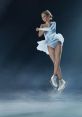 Female figure skater performing an elegant jump in a stunning light blue costume, showcasing grace and athleticism on ice.