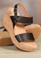 Stylish black wedge sandals with cork platform, perfect for summer outfits and casual elegance. Discover Easha Sandapen's designs.