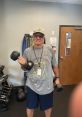 Senior man exercising with dumbbells, showcasing dedication to fitness and health, with U.S. Army-themed apparel.