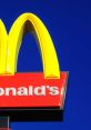 Bright yellow McDonald's arches against a blue sky, showcasing the iconic logo of this popular fast-food chain.