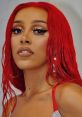 Doja Cat flaunts a bold red hairstyle and striking makeup, showcasing her unique style and confidence.