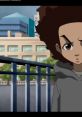 Huey Freeman stands pensively by a railing, with a modern cityscape behind him in "The Boondocks."