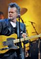 John Mellencamp John Mellencamp is an American rock ian, singer-songwriter, and painter who has made a lasting impact on the