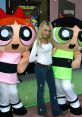 E. G. Daily poses with Buttercup and Blossom from The Powerpuff Girls at a promotional event, showcasing her voice acting role.