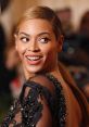 Beyoncé smiles elegantly in a glamorous black outfit, showcasing her iconic style at a high-profile event.