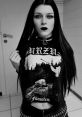 Gothic style portrait featuring a young woman in a black Burzum Filosofem shirt, with striking dark makeup and long hair.