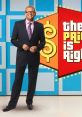 Drew Carey smiles confidently in a sharp suit near "The Price is Right" iconic colorful backdrop featuring dollar signs.