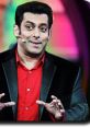 Salman Khan engaging with the audience on Bigg Boss, showcasing his lively personality in a vibrant studio setting.