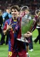 Lionel Messi celebrating UEFA Champions League victory, holding the trophy and flashing a victory sign.