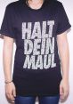 Halt die-dein Maul The words "Halt die dein Maul" reverberate through the air, sharp and cutting. The harsh consonants