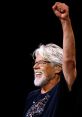 Bob Seger performs live, smiling and raising his fist in excitement, showcasing his passion for rock music on stage.