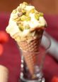 Pistachio ice cream topped with nuts in a cone, showcasing the delicious flavors of iErqn Ice Cream.