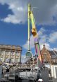 TURBO OP DE TURBO ride towering against a bright sky at a lively Kermis event, showcasing vibrant colors and excitement.