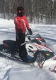 Jacob M. riding a snowmobile in a snowy forest, showcasing winter adventure and outdoor sports enthusiasm.