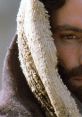 Close-up of a man’s face with a solemn expression, draped in a textured cloth, evoking themes from "The Passion of the Christ.