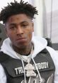 NBA Youngboy wears a distinctive outfit with a bear pendant, showcasing his unique style and persona in the music scene.