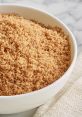 Close-up of brown sugar in a bowl, showcasing its rich color and fine texture, perfect for baking and sweetening recipes.