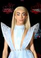 Bilal Hassani at the NRJ Music Awards in a stunning light blue gown, showcasing his unique fashion style and charisma.