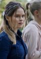 Young woman with a thoughtful expression, wearing a denim shirt and hairband, featured in Hellstrøm - Ruth sommerfugler.