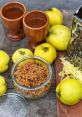 Quince fruits, grated and dried quince shavings in a jar, and clay mugs on a rustic wooden table. Perfect for "Anders kan du torka.