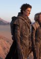 Paul Atreides and Chani in futuristic armor on Arrakis, capturing the essence of Dune's epic desert landscape.