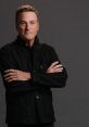 Michael W. Smith poses confidently, wearing a black jacket, showcasing his signature style and approachable charm.