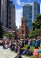 Dancers perform at the Yerba Buena Gardens Festival, captivating a diverse audience amid a vibrant urban backdrop.