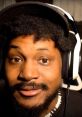 Coryxkenshin smiling with headphones, showcasing his engaging personality and unique style in gaming content creation.