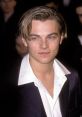 Young Leonardo DiCaprio with styled hair and a sharp suit, showcasing his early Hollywood charm and charisma.