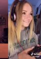 Australian TikTok gamer girl with long hair, headphones, and a game controller, smiling while playing Xbox.