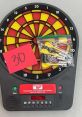 TRIPLE 18 - Electric Dart The of a dart hitting its target with precision echoes through the room, a metallic clink that