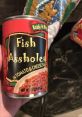 Can of "Fish Assholes" in tomato and cheese sauce, a humorous and quirky food item. Perfect for meme culture.