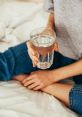 Person holding a glass of water, promoting hydration and well-being. "Ja bebeu água hoje?" encourages daily water intake.