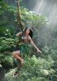 Katy Perry in a jungle-themed outfit, swinging from a vine surrounded by lush greenery, embodying an adventurous spirit.