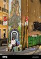 Colorful urban mural featuring a woman relaxing, showcasing vibrant street art and a unique city vibe for TheNaOui.