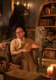 Nandor ponders in the cozy lair, surrounded by candles and a bear, reflecting the eerie charm of What We Do in the Shadows - Season 2.