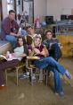 Freaks and Geeks cast seated in a classroom, embodying the show's teenage struggles and friendships in Season 1.