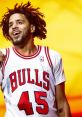 J. Cole performing in a Chicago Bulls jersey, showcasing his vibrant energy against a colorful backdrop.