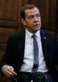 Dmitry Medvedev in a formal setting, discussing policy matters in Russia, showcasing a focused expression and attire.