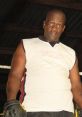 Athlete from Themba, Zulu South Africa, wearing boxing gloves and a sleeveless shirt, ready for training in the gym.